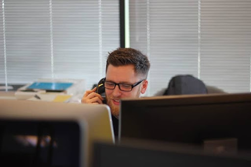 Man speaks on the phone taking a sign customer to do a quote online