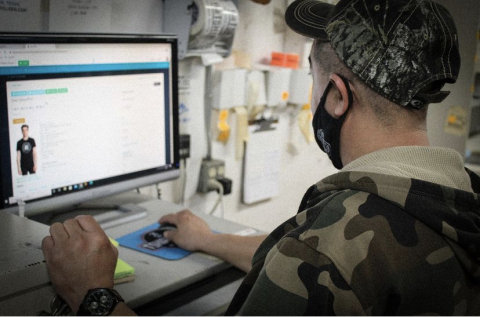 Sales rep adding a custom printed apparel item to a shopVOX Sales Order on the computer.