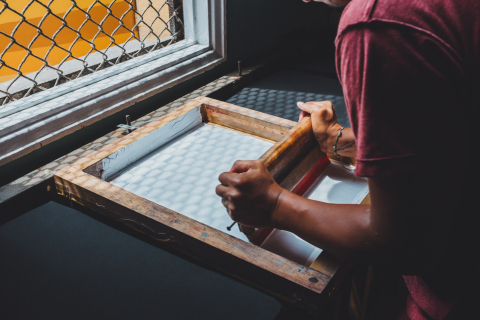 Man screen printing.