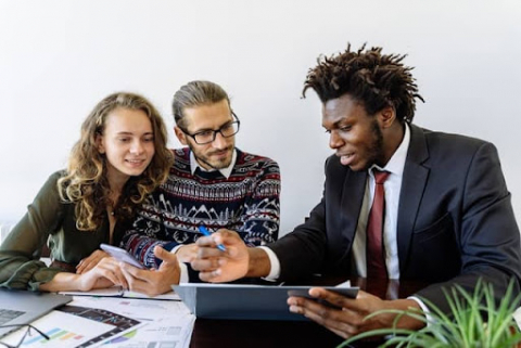 A print shop salesman uses an online print shop management software to consult with a client.